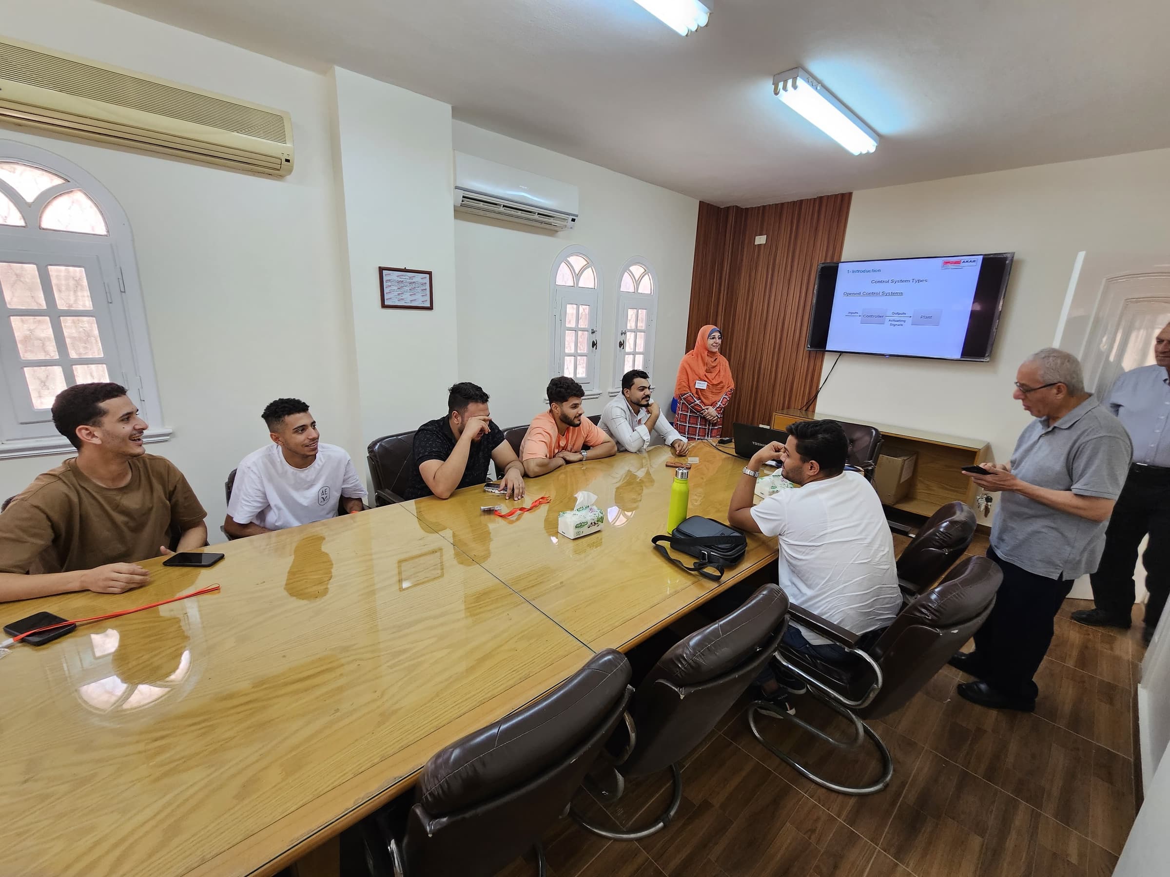 A trainer leading a control-systems session for a cohort